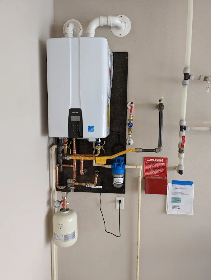 Professional plumber installing copper piping in a Cumru home